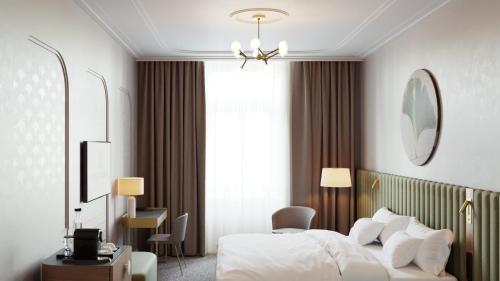 a hotel room with a bed and a window at Palatinus Grand Hotel in Pécs