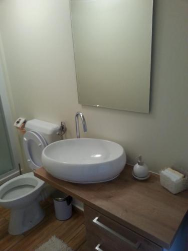 a bathroom with a white sink and a toilet at Apartment Peky in Rab