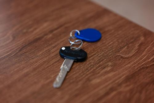 a blue key chain on a wooden table at Olja in Sarajevo