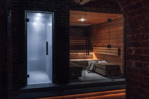 a glass door in a room with a sauna at Harbour Hotel & Spa Brighton in Brighton & Hove