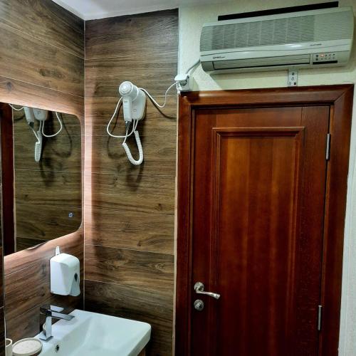 a bathroom with a sink and a mirror and a toilet at Apartman HOME Kotor in Kotor