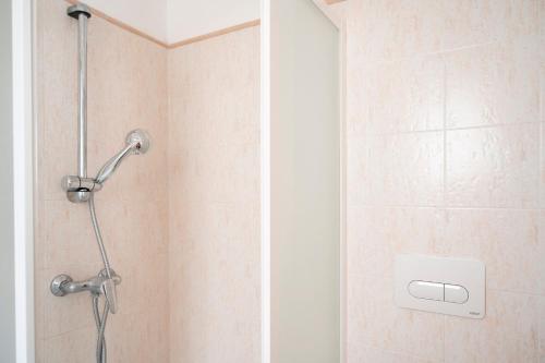 a shower with a shower head in a bathroom at Nel Cuore Del Salento Dimora Tipica in Calimera
