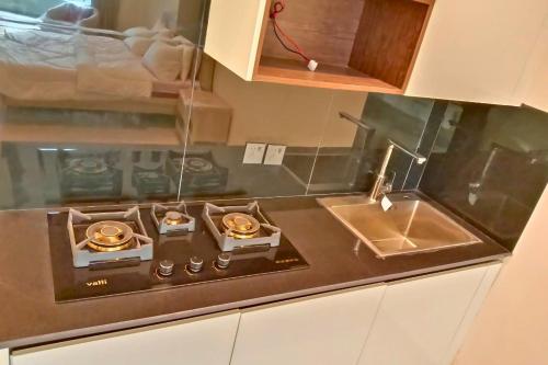 a kitchen with a stove and a sink at 1 Bed Luxury Studio with Mountain View in Murree