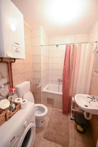 a bathroom with a toilet and a sink and a tub at Olja in Sarajevo