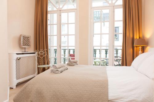 a bedroom with a bed and a large window at Livia's Hideaway Canalbelt in Amsterdam