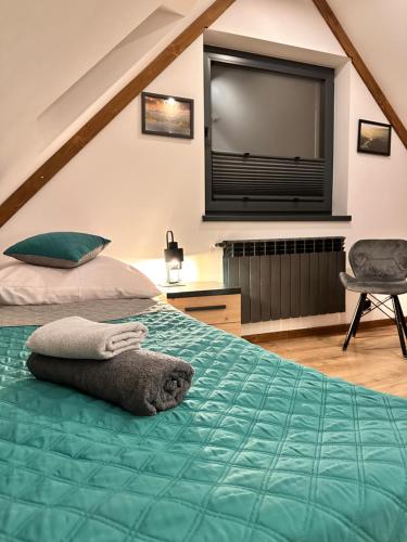 a bedroom with a bed with a flat screen tv at Twoje Miejsce in Czarna Góra