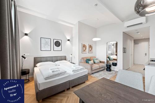 um quarto com uma cama e uma sala de estar em easy flat Stadtpark Apartments em Viena