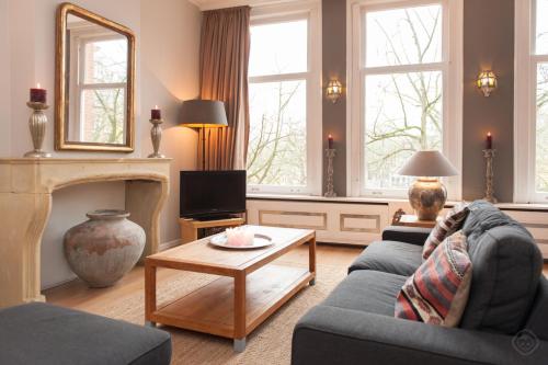 a living room with a couch and a fireplace at Livia's Hideaway Canalbelt in Amsterdam