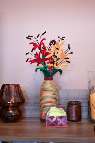 a vase with flowers in it sitting on a table at Olja in Sarajevo
