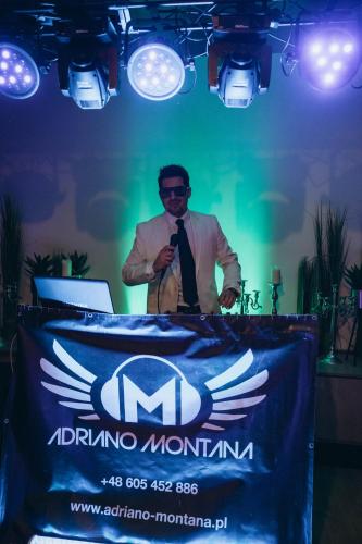 a man standing at a table with a microphone at Apartamenty Rondo in Świnoujście
