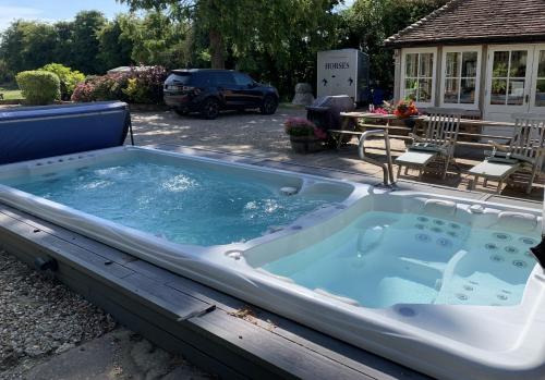 a jacuzzi tub sitting in a yard at Molland Manor House Bed & Breakfast in Sandwich