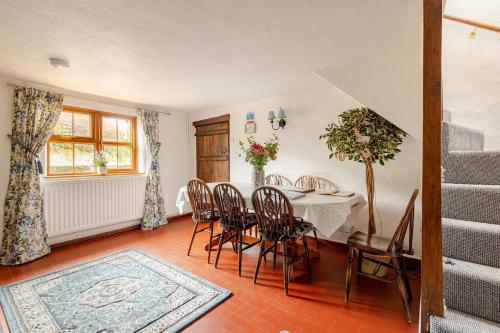 a dining room with a table and chairs at Luxury Village Cottage on doorstep of Alton Towers in Alton