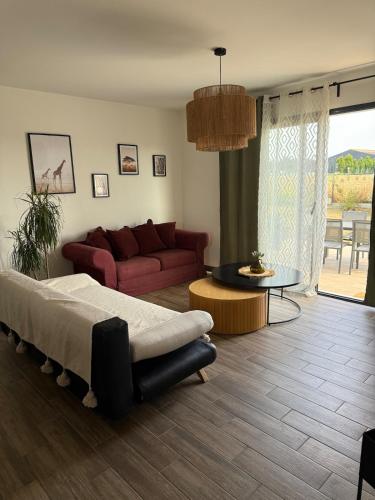 a living room with a bed and a couch at Maison neuve in Montamisé