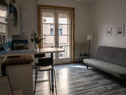 a living room with a kitchen and a couch at Chic Asboth City Center Loft - Perfect Location in Budapest