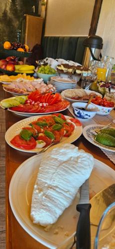 a table filled with plates of food on a table at Tarninowe Wzgórze in Kunkowa