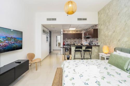 a hotel room with a bed and a bar at Luxury Studio - Golf Views - Sports City Dubai in Dubai