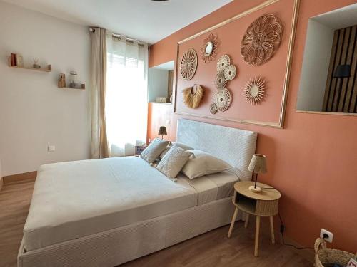 a bedroom with a bed and a wall with plates at F3 quartier historique, parking gratuit, vue Saône in Chalon-sur-Saône