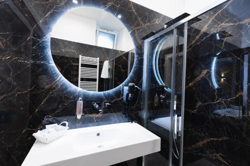 a bathroom with a sink and a mirror at BeHome in Trani