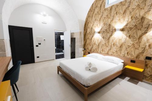 a bedroom with a bed with two shoes on it at BeHome in Trani