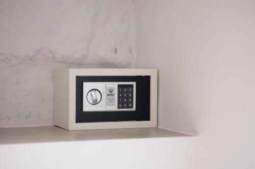 a white microwave oven sitting on a shelf at BeHome in Trani