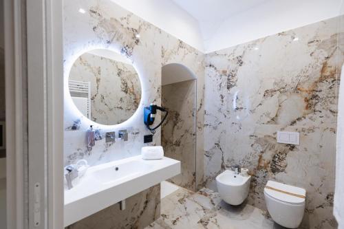 a bathroom with a sink and a mirror at BeHome in Trani