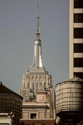 a large building with a tower on top of it at Newly Renovated Rooms at Club Quarters Hotel Times Square, New York in New York