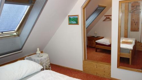 a bedroom with a mirror and a bed in a room at Chalupa Obora in Cerhonice