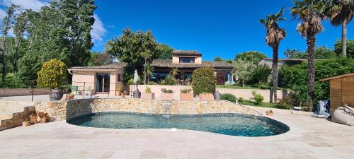 a house with a swimming pool in front of a house at Villa Martinus in Saint-Paul-de-Vence