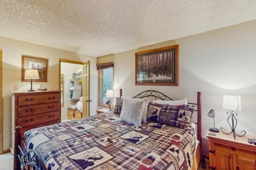 a bedroom with a bed with a quilt on it at Ten Mile Haus in Frisco
