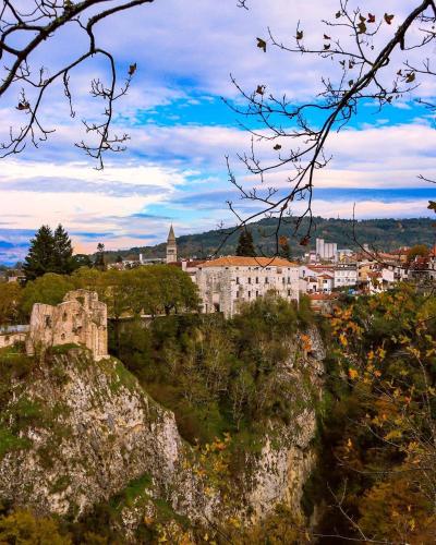 a castle on a hill with a city in the background at Prospect in Motovun