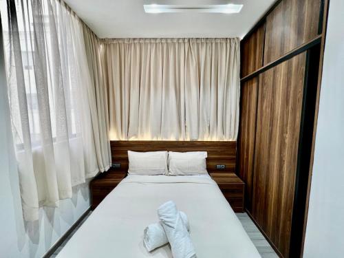 a bedroom with a bed with two towels on it at Bright Corniche Escape - 2 BR Urban Flat in Tangier