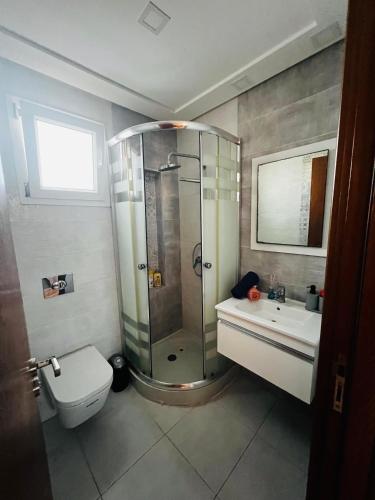 a bathroom with a shower and a toilet and a sink at Appartement S1 Haut Standing Monastir in Monastir