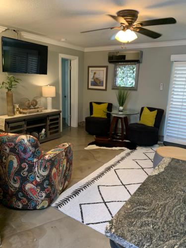 a living room with two chairs and a ceiling fan at Florida Keys in Marathon