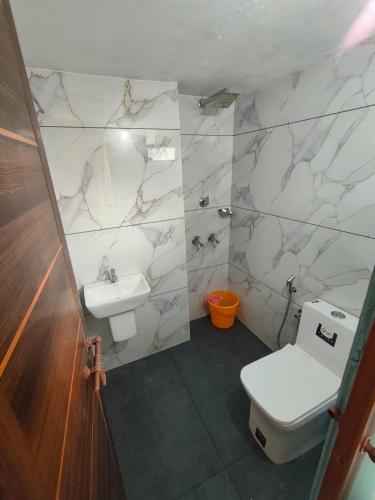 a bathroom with a toilet and a sink at IDANN Homestay in Cochin