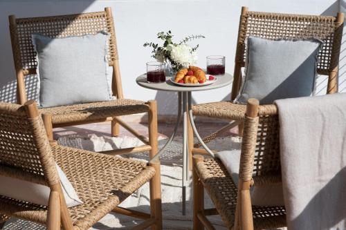 a patio with two chairs and a table with a plate of food at 1bd Sv Beach Condo With Pool in Athens