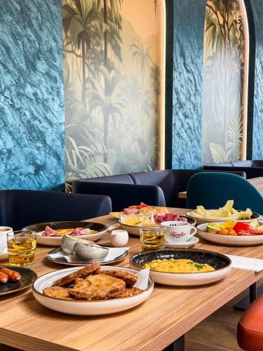 a table with many plates of food on it at TILIA Resort in Dolný Kubín