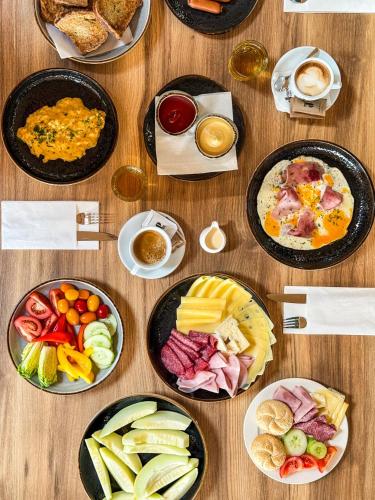 a wooden table with plates of food on it at TILIA Resort in Dolný Kubín