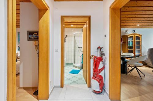 a room with a door leading to a bathroom with a shower at Ferienhaus Sonnenplatz Am See in Roding