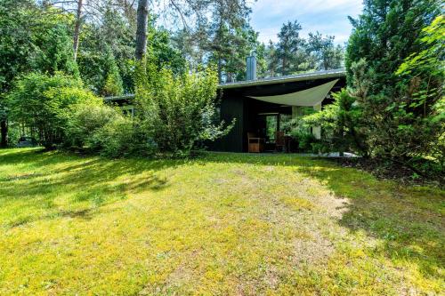 a house in the woods with a yard at Ferienhaus Sonnenplatz Am See in Roding