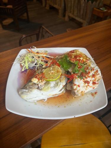 a plate of food with a fish on a table at Better View Koh Yao Yai in Ko Yao Yai