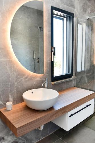 a bathroom with a white sink and a mirror at Moddissi Charme in Trappola
