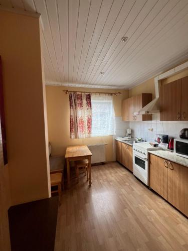 a small kitchen with a table and a stove at Cozy apartment near Santariskes in Vilnius