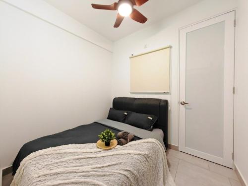 a bedroom with a bed and a ceiling fan at Astetica5 4BR Spacious Home w Netflix WiFi in Serdang