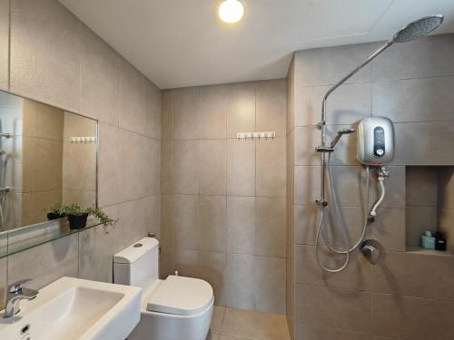 a bathroom with a shower and a toilet and a sink at Astetica5 4BR Spacious Home w Netflix WiFi in Serdang