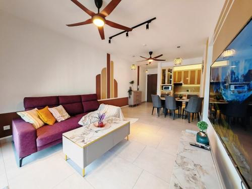 a living room with a purple couch and a table at Astetica5 4BR Spacious Home w Netflix WiFi in Serdang