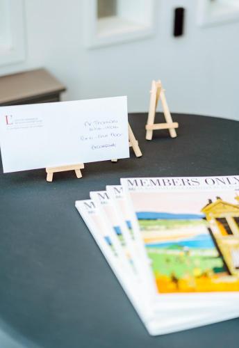 a table with a sign and a pile of papers at Relais de L'Empereur in Genappe