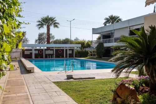 a swimming pool in front of a building at 1bd Sv Beach Condo With Pool in Athens