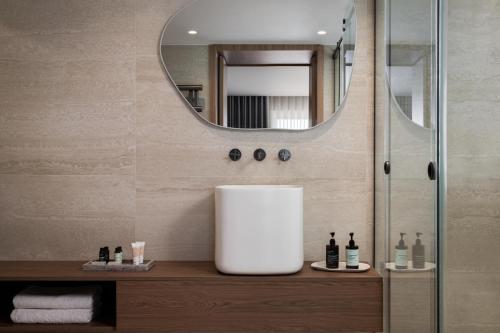 a bathroom with a sink and a mirror at 1bd Sv Beach Condo With Pool in Athens