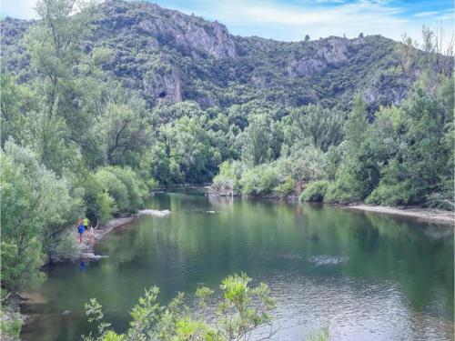 a person standing on a rock in a river at Hillside Retreat in Roquebrun in Roquebrun