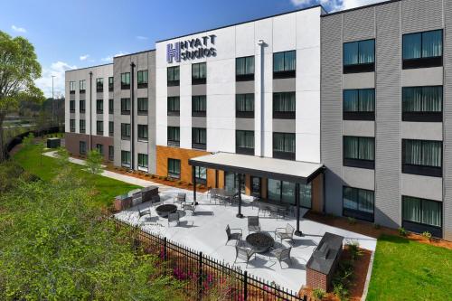 an office building with a courtyard with tables and chairs at Hyatt Studios Mobile/Tillmans Corner in Mobile